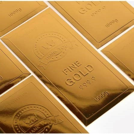 Shiny old bar envelopes with 'Fine Gold' and '99.9%' text on them.
